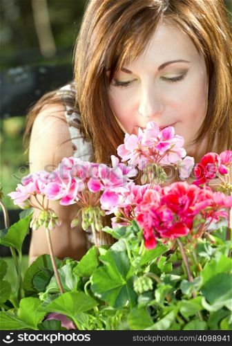 bright picture of lovely housewife potting plants (focus on nose and petals)