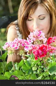 bright picture of lovely housewife potting plants (focus on nose and petals)