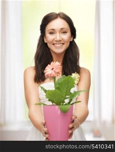bright picture of lovely housewife with flower in pot