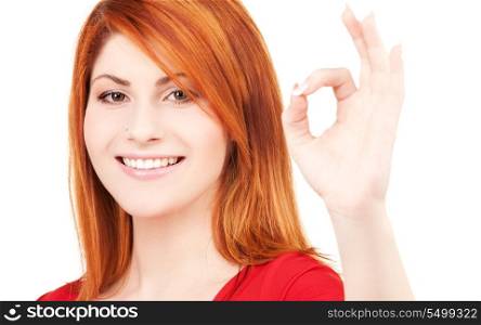 bright picture of lovely redhead showing ok sign
