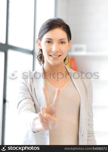 bright picture of lovely teenage girl showing victory sign