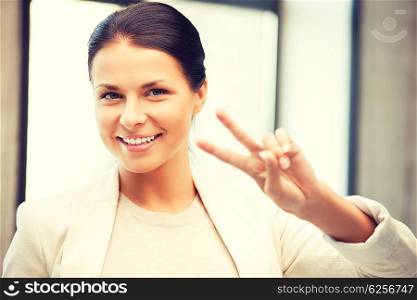 bright picture of lovely teenage girl showing victory sign. victory