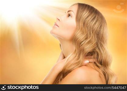 bright picture of lovely woman over golden background