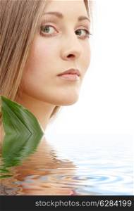 bright picture of lovely woman with green leaf in water