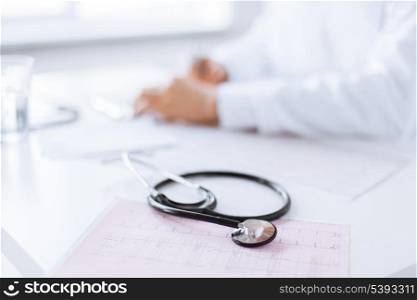 bright picture of male doctor hands with cardiogram