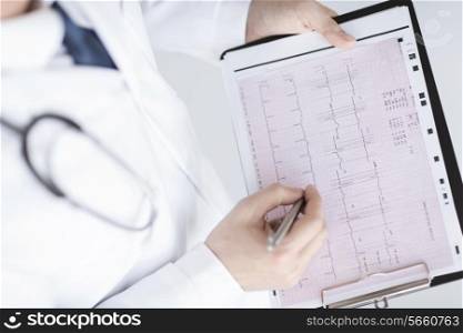 bright picture of male doctor hands with cardiogram