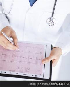 bright picture of male doctor hands with cardiogram. male doctor hands with cardiogram