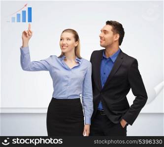 bright picture of man and woman pointing their fingers to chart