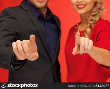 bright picture of man and woman pressing virtual button