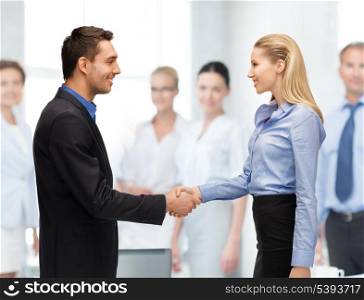 bright picture of man and woman shaking their hands