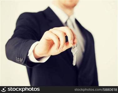 bright picture of man hand holding house keys