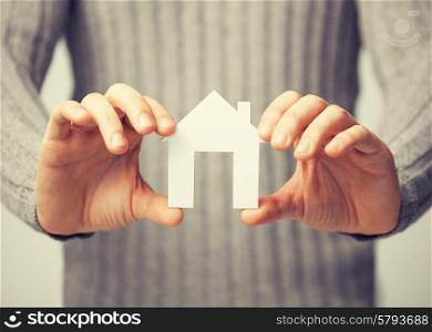 bright picture of man holding paper house