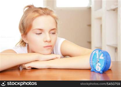 bright picture of pensive teenage girl with clock