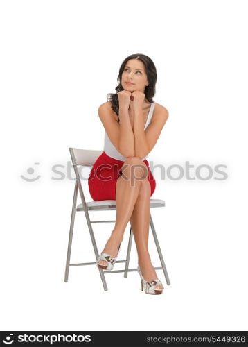 bright picture of pensive woman on a chair