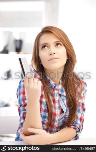 bright picture of pensive woman with credit card
