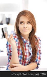 bright picture of pensive woman with credit card