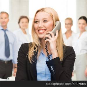 bright picture of smiling woman with phone in office