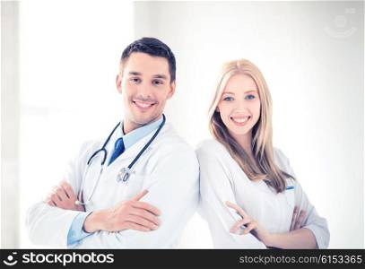 bright picture of two young attractive doctors. two young attractive doctors