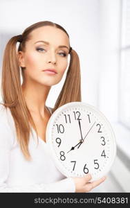 bright picture of woman holding big clock