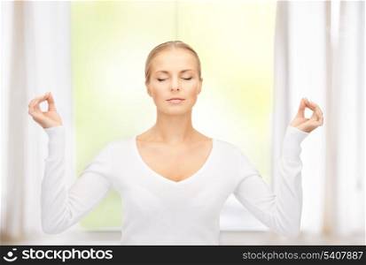 bright picture of woman in meditation at home