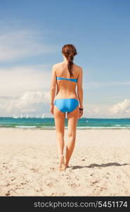 bright picture of woman on the beach.