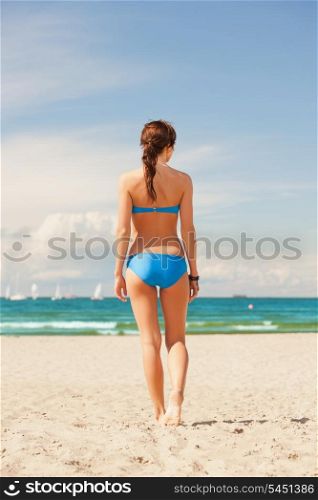 bright picture of woman on the beach.
