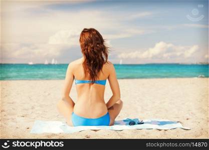 bright picture of woman sitting on a towel