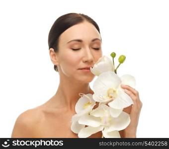 bright picture of woman smelling white orchid flower.