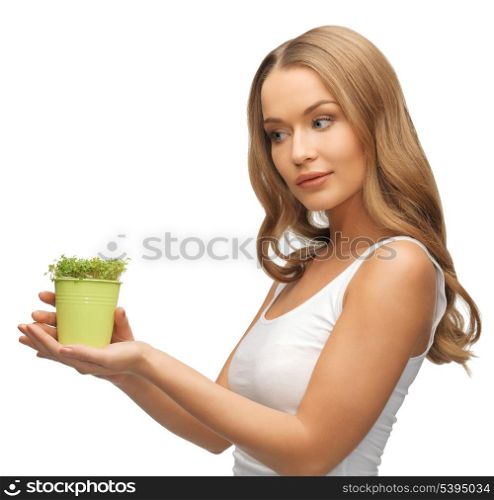 bright picture of woman with green grass in pot