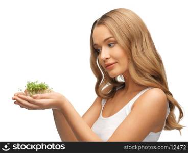 bright picture of woman with green grass on palms