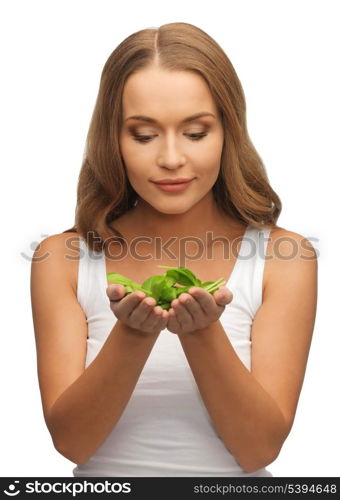 bright picture of woman with spinach leaves on palms