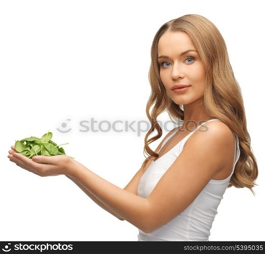 bright picture of woman with spinach leaves on palms