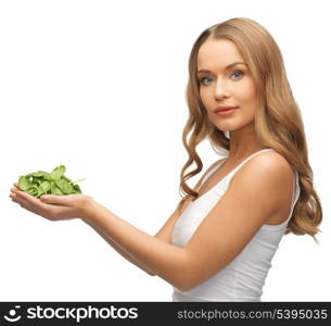 bright picture of woman with spinach leaves on palms