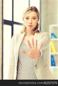bright picture of young woman making stop gesture. woman making stop gesture