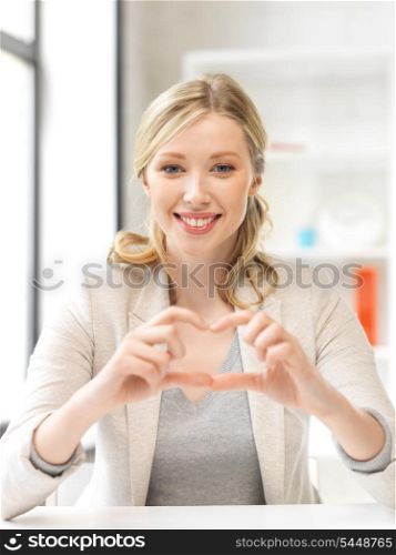 bright picture of young woman showing heart sign
