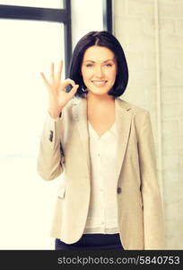 bright picture of young woman showing ok sign. young woman showing ok sign