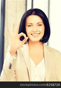 bright picture of young woman showing ok sign. young woman showing ok sign