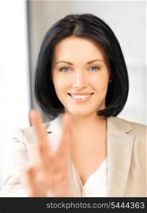 bright picture of young woman showing victory sign