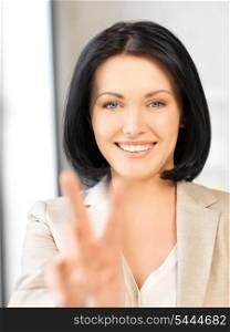 bright picture of young woman showing victory sign