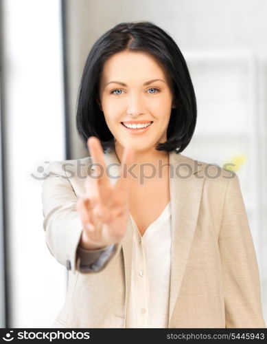 bright picture of young woman showing victory sign