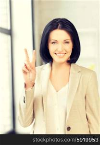 bright picture of young woman showing victory sign. victory
