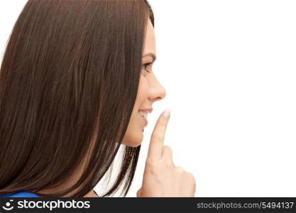 bright picture of young woman with finger on lips.