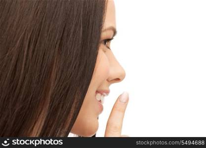 bright picture of young woman with finger on lips.