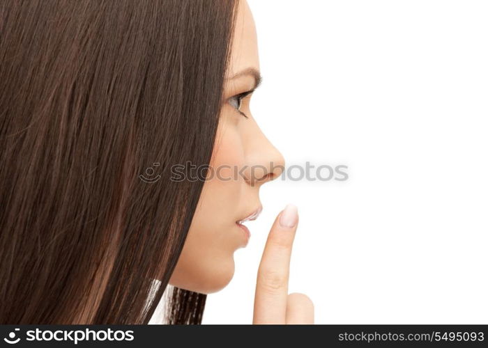 bright picture of young woman with finger on lips.