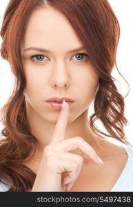 bright picture of young woman with finger on lips