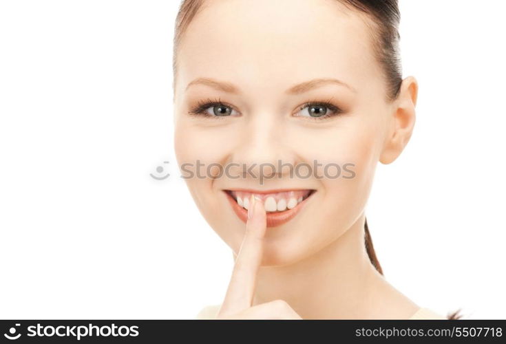 bright picture of young woman with finger on lips