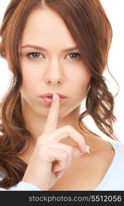 bright picture of young woman with finger on lips