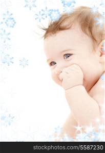 bright portrait of adorable baby with snowflakes