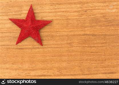 Bright red Christmas star on a wooden background with copyspace