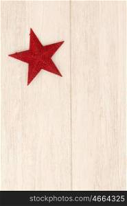 Bright red Christmas star on a wooden background with copyspace